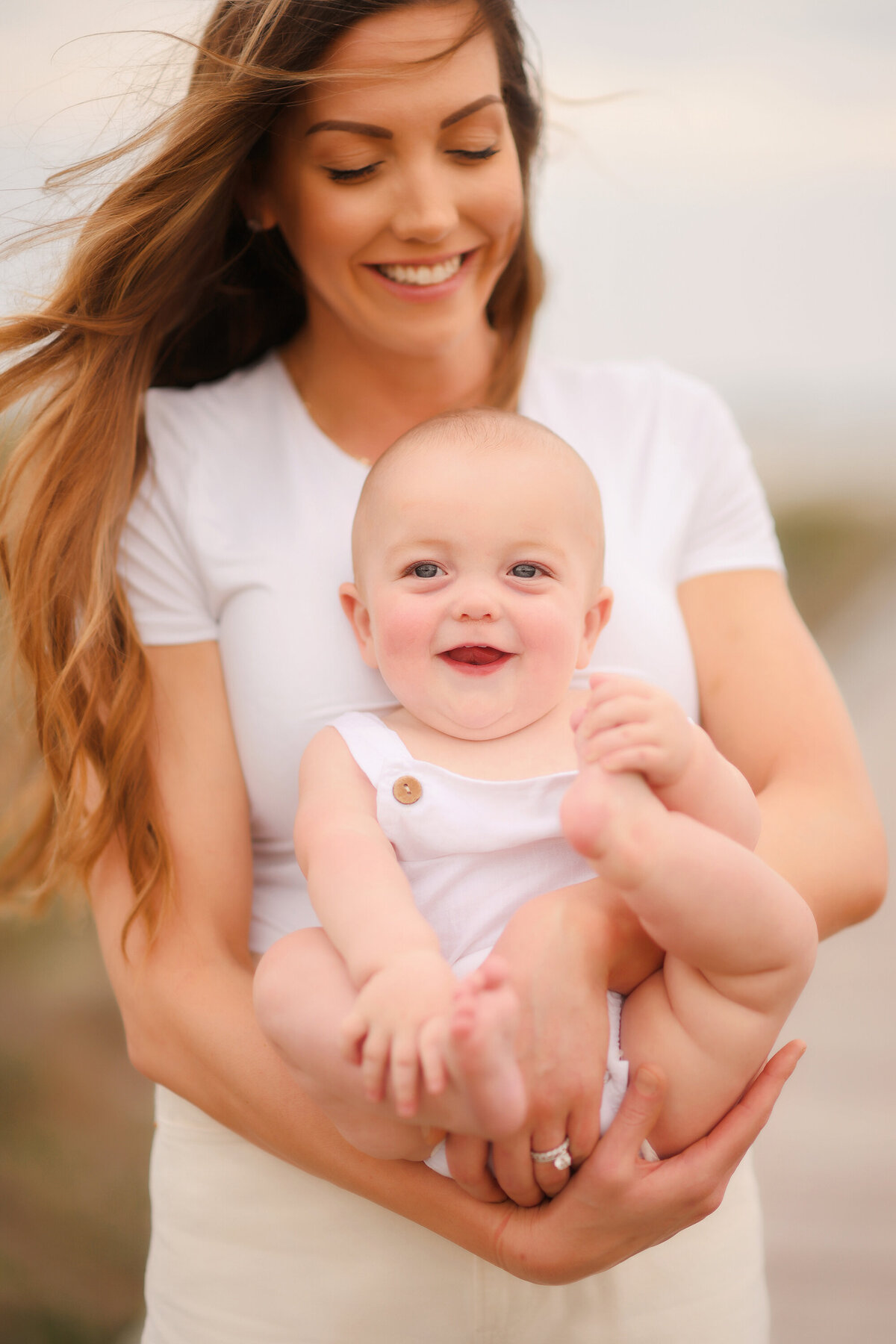 Mother embraces her baby during Family Photos on Isle of Palms. 