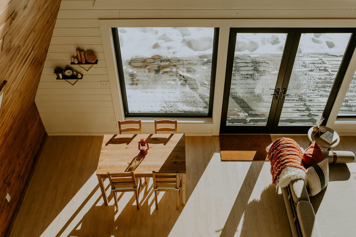 Looking down at the lower level of an aframe cabin.