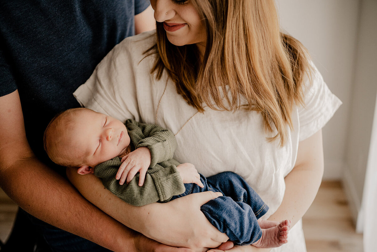 Family holds baby for Loveland Newborn Photographer