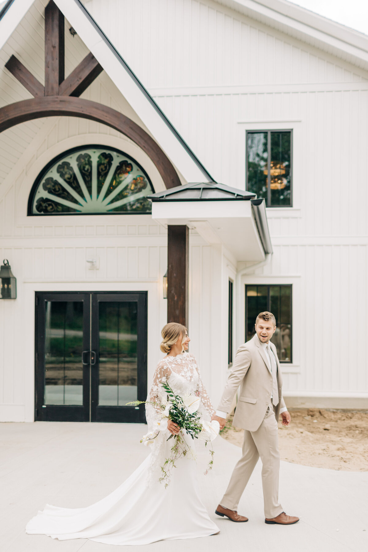 bride and groom walking outside venue