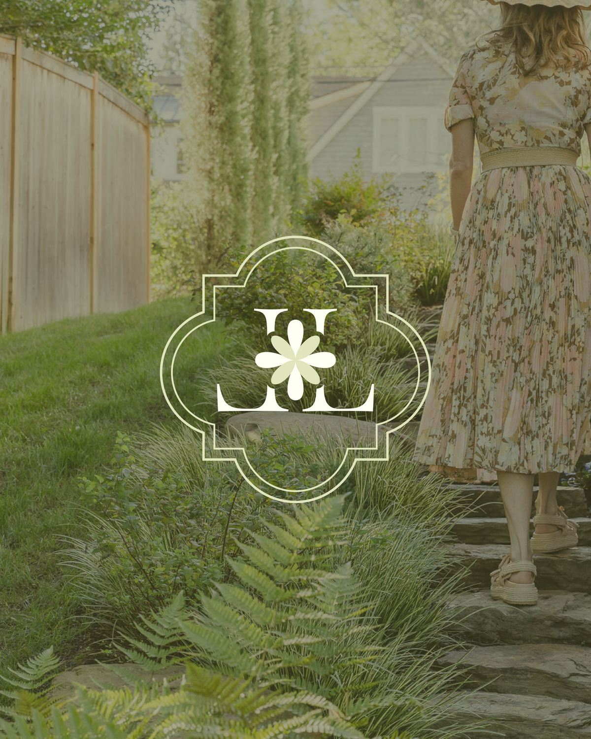 Soft floral monogram logo overlayed on lush garden path, designed to reflect romantic, elevated branding for outdoor creatives.