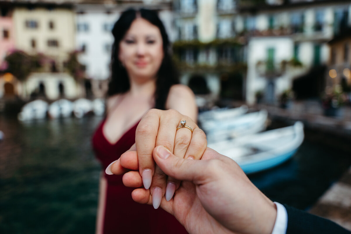 Close-up of engagement ring held out toward camera