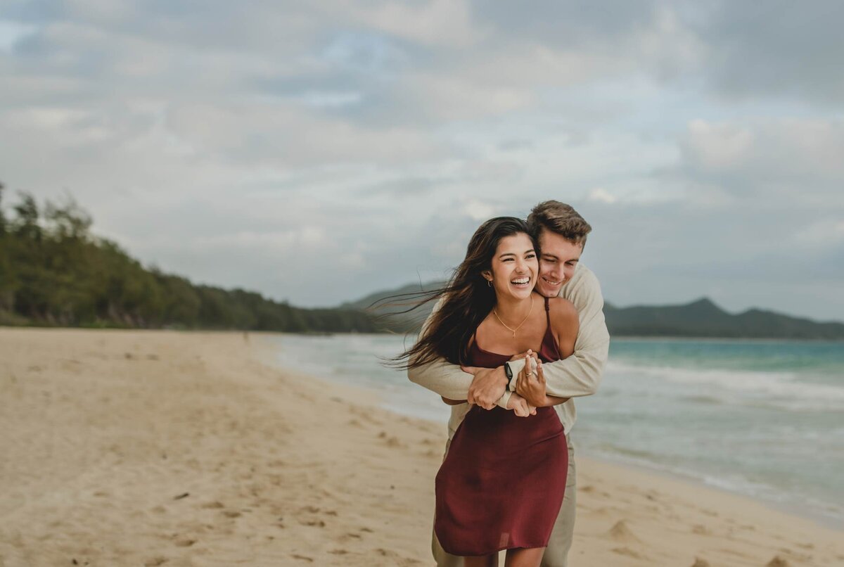 couple-laughing-hugging-beach-Hawaii