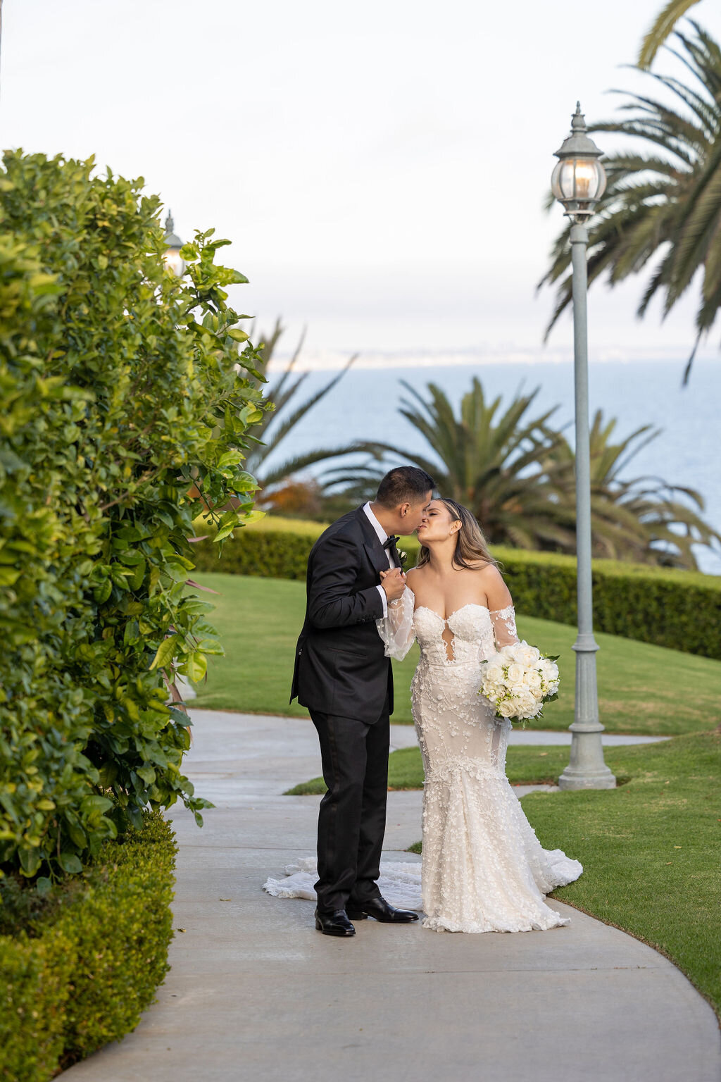 Couple kissing overlooking the Pacific Ocean