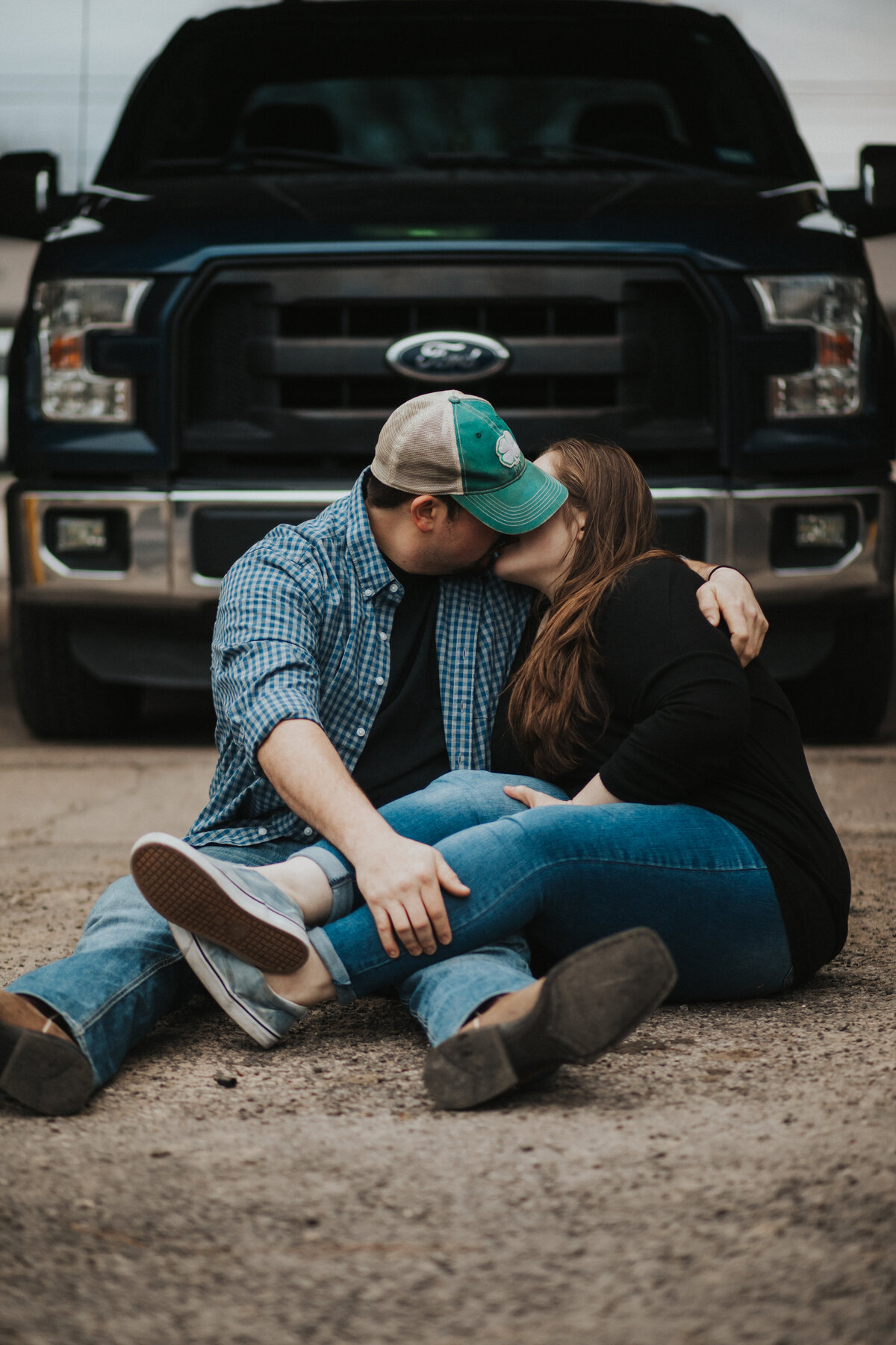couple kissing in front of truck during texas engagement photos