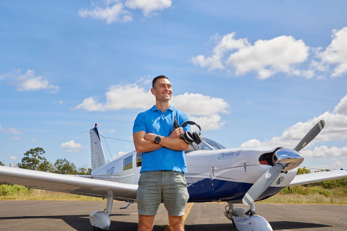 Pilot Nathan Bridge from Chiropractic works in front of his plane at mareeba airport