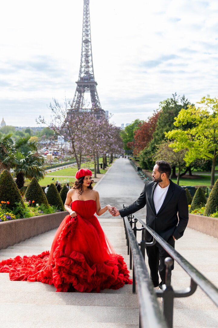 Spring Paris couple photography, cherry blossoms, stairs pose, Eiffel Tower view, romantic session