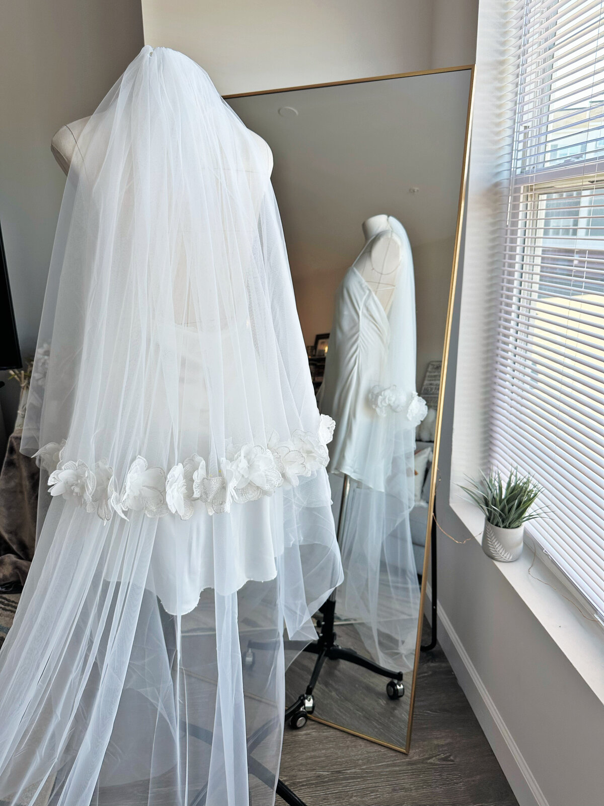 Bride wearing soft tulle blusher veil with lace edge