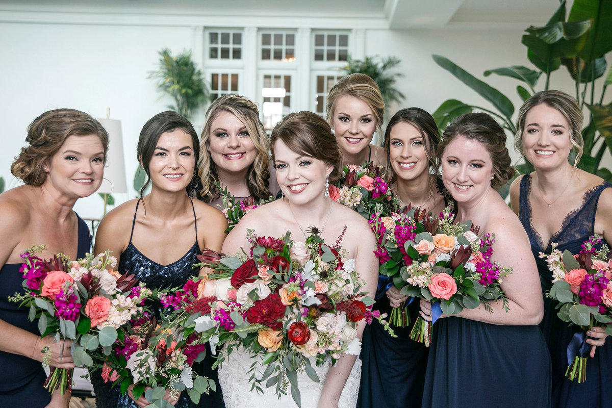 Bride and  bridesmaids posing with bouquets at The Lesner Inn