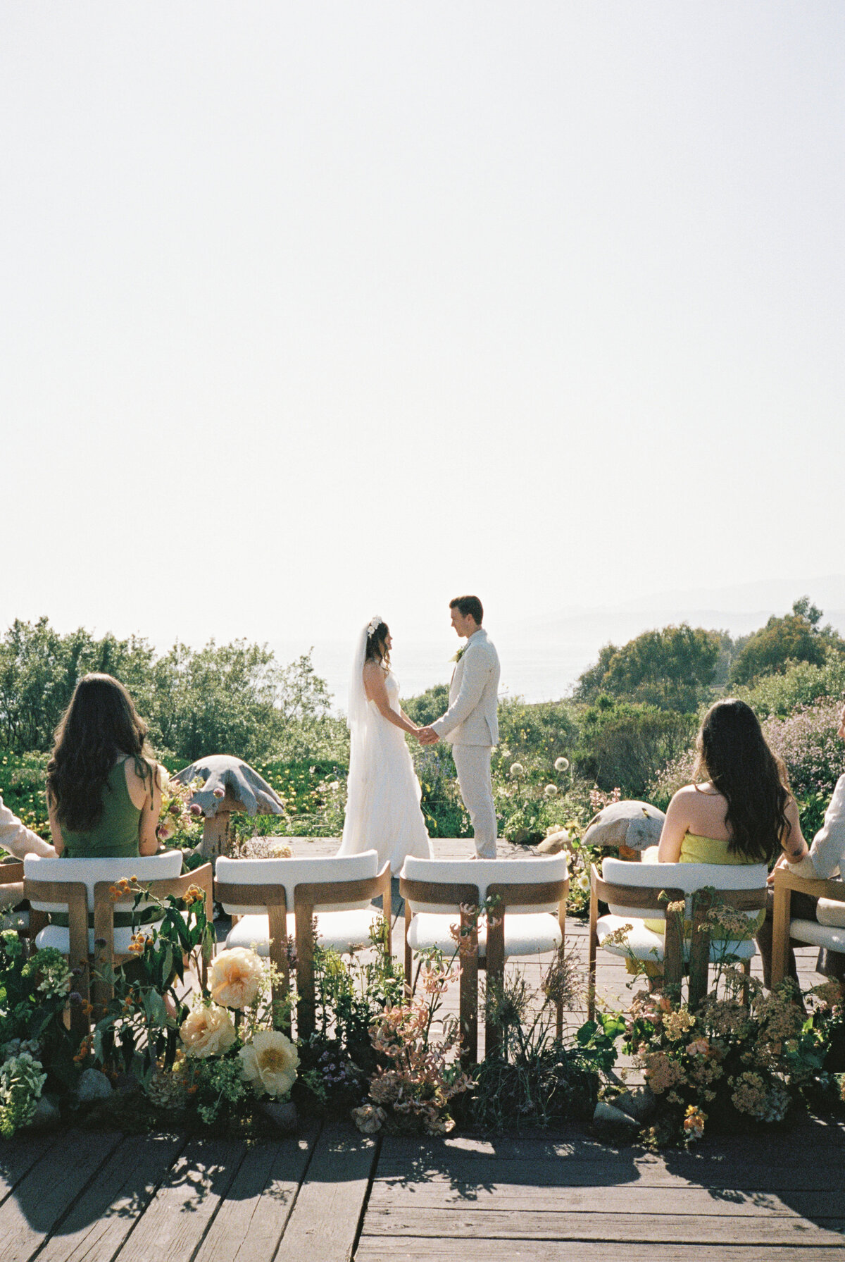Couple sharing their vows at Dos Pueblos Orchid Farm in San Diego, California, surrounded by the venue's stunning natural beauty.