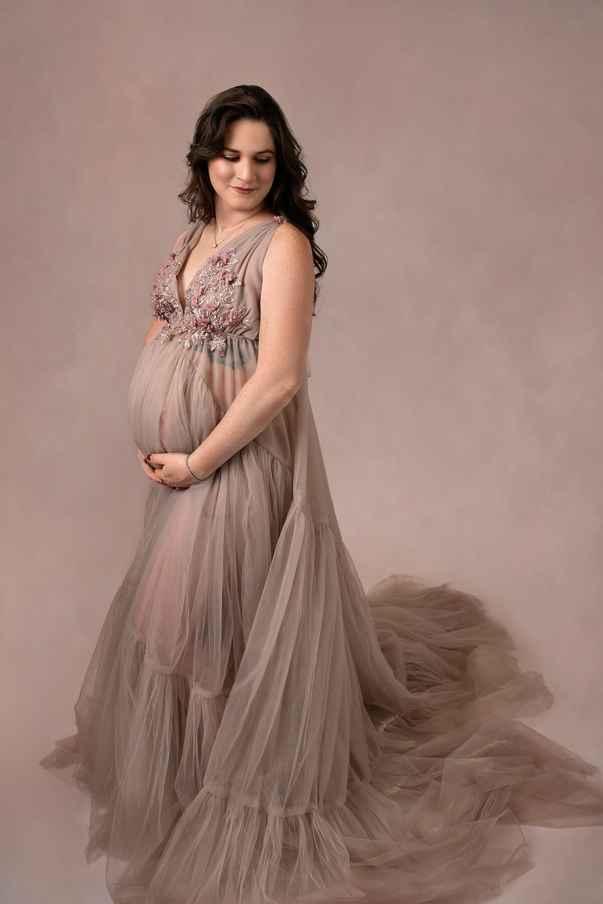 Beautiful pregnant woman in a tulle gown in shades of mauve, photographed in Houston by Laura King Photography