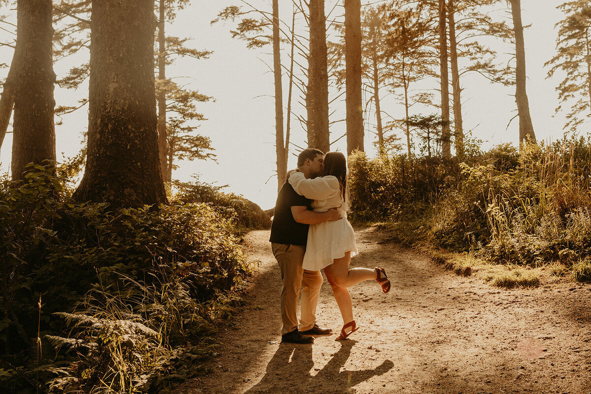 Couple kissing surrounded by trees