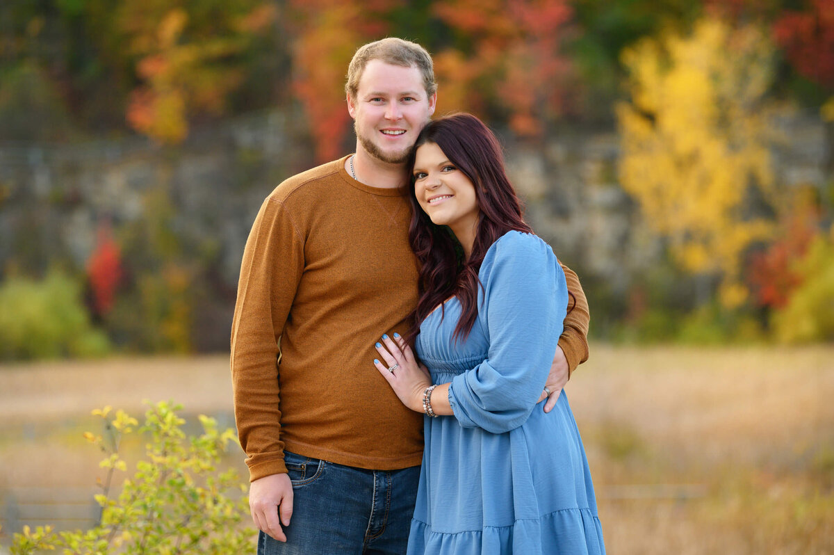 Husband and wife cuddling for their fall family photos