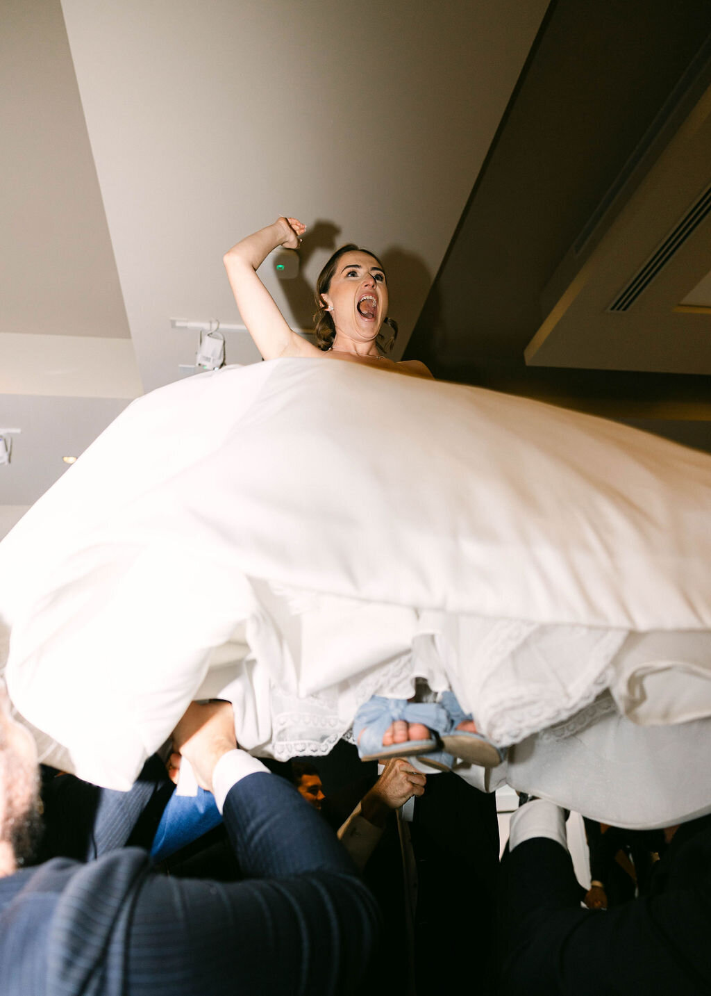 Bride lifted during hora chair dance celebration at Arizona wedding.