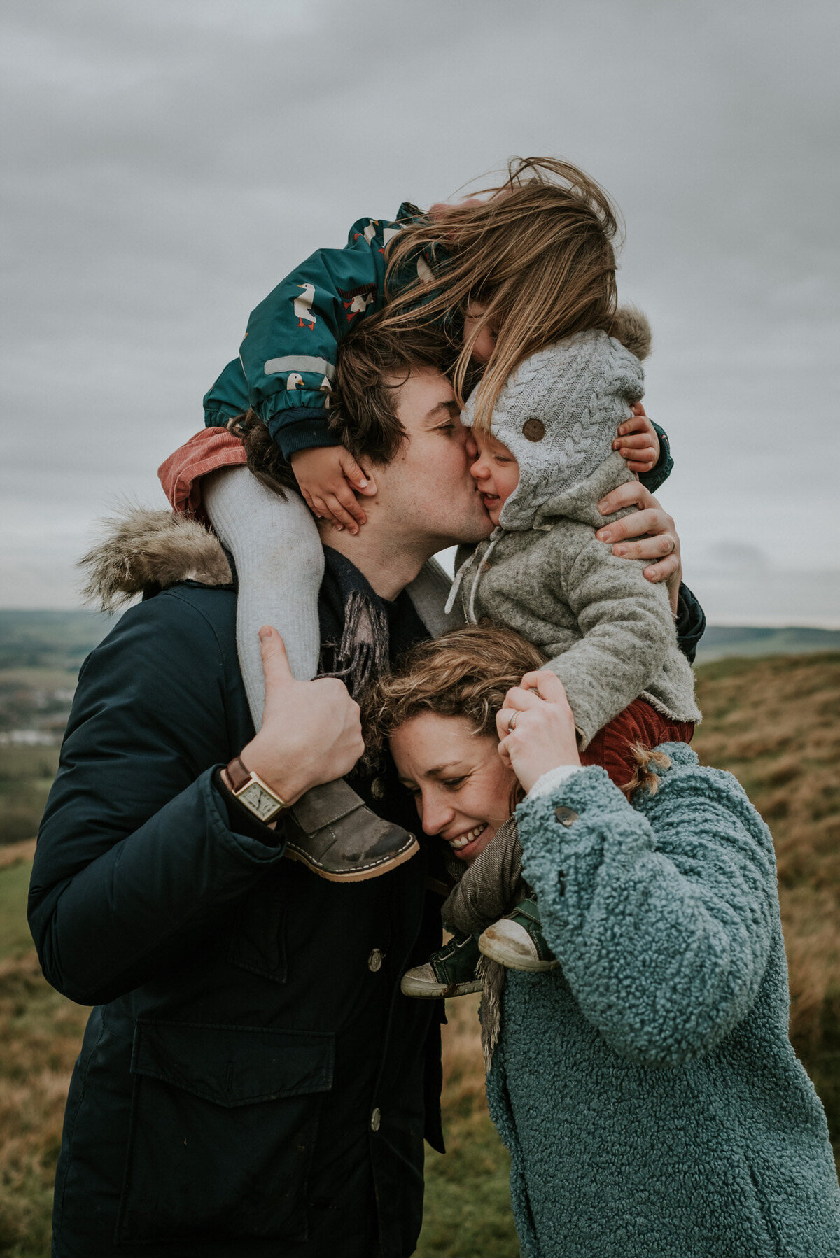 couple lifting up children for family photo