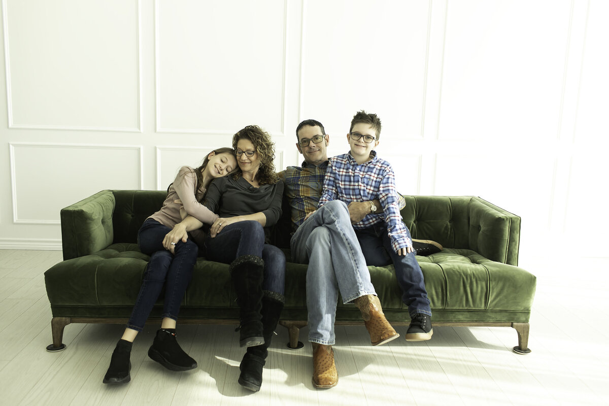 Parents and kids sharing a lighthearted, fun-filled moment as they strike playful poses for their family photoshoot