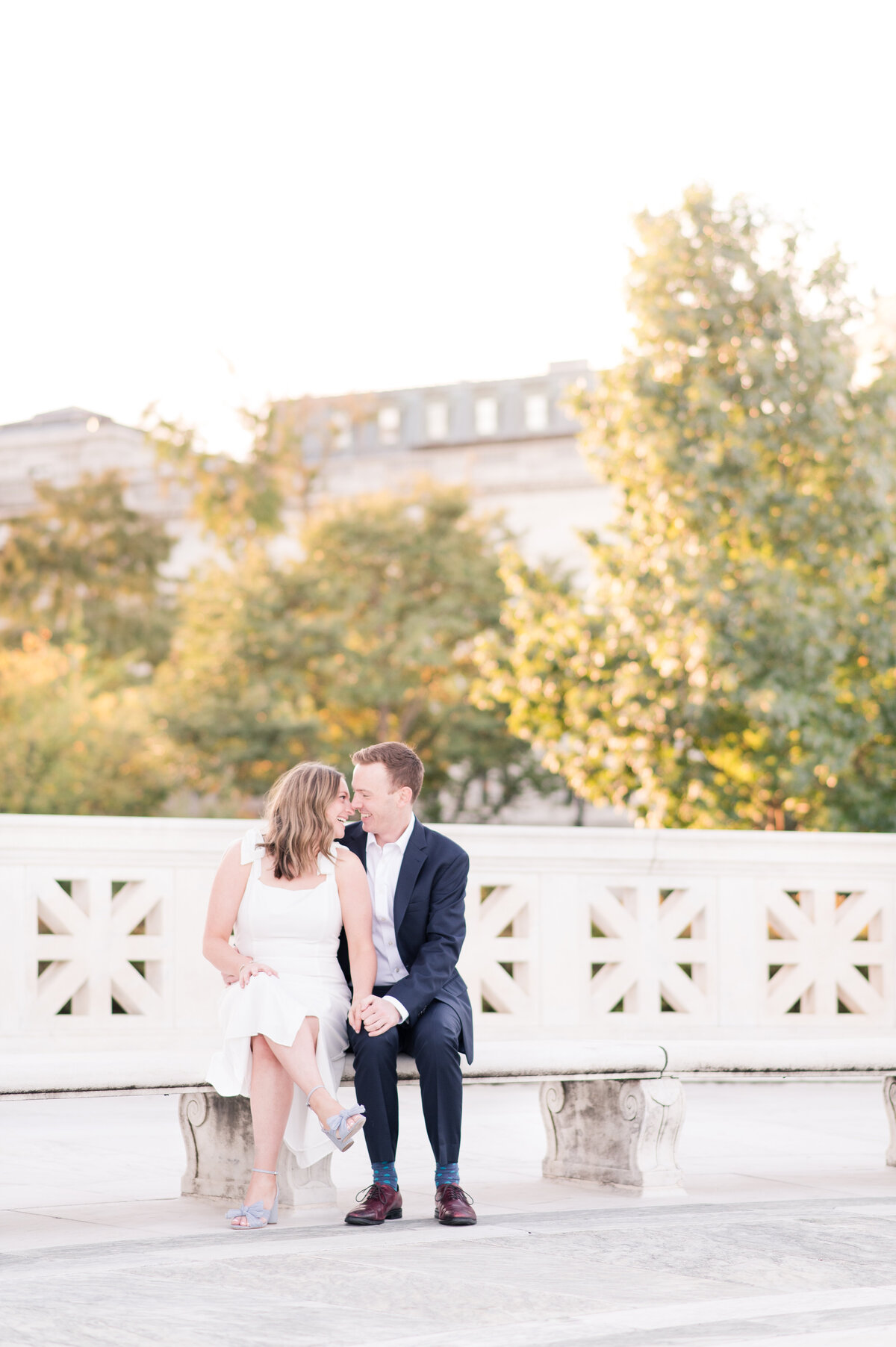 couple sitting on marble bench at sunrise