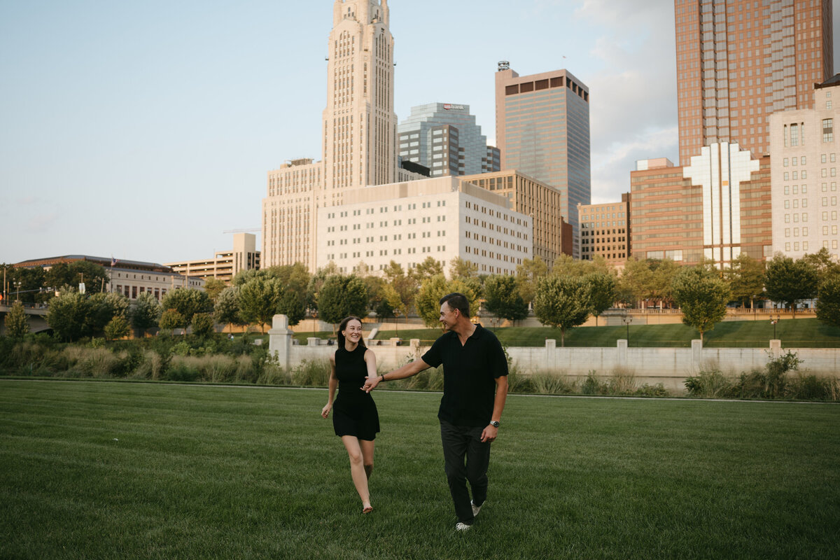 happy couple walking in city park