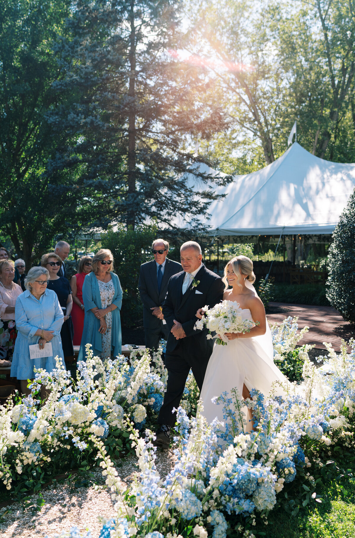 A bride and her dad walk down a flower-lined aisle at The Cypress House in Pennsylvania.
