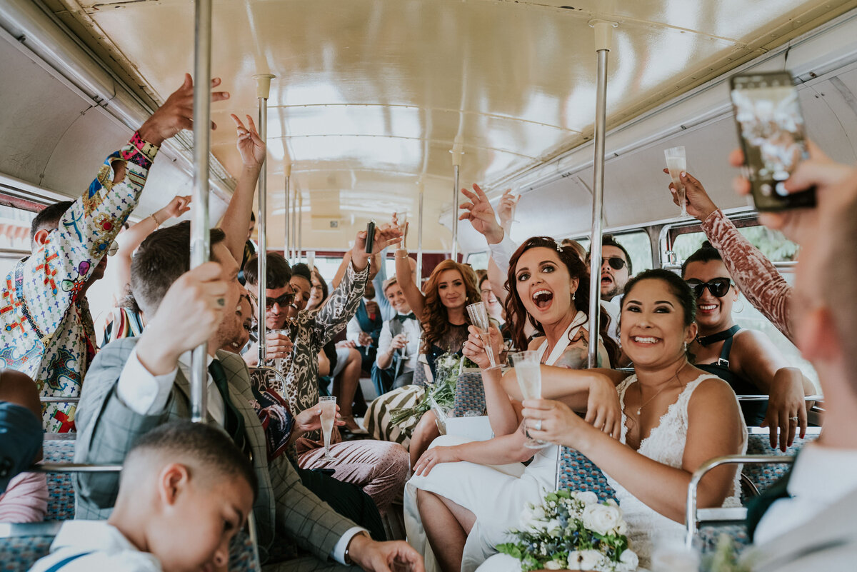 Wedding party celebrating in party bus