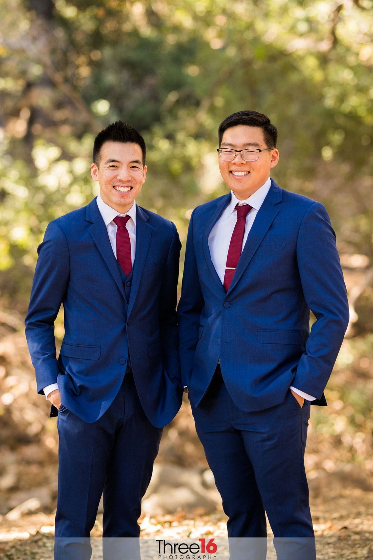 Groom and his Best Man pose together in their blue suits