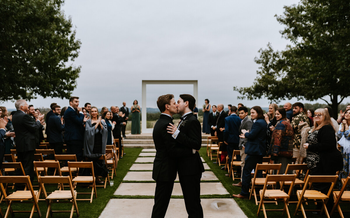 groom and groom kissing at ceremony