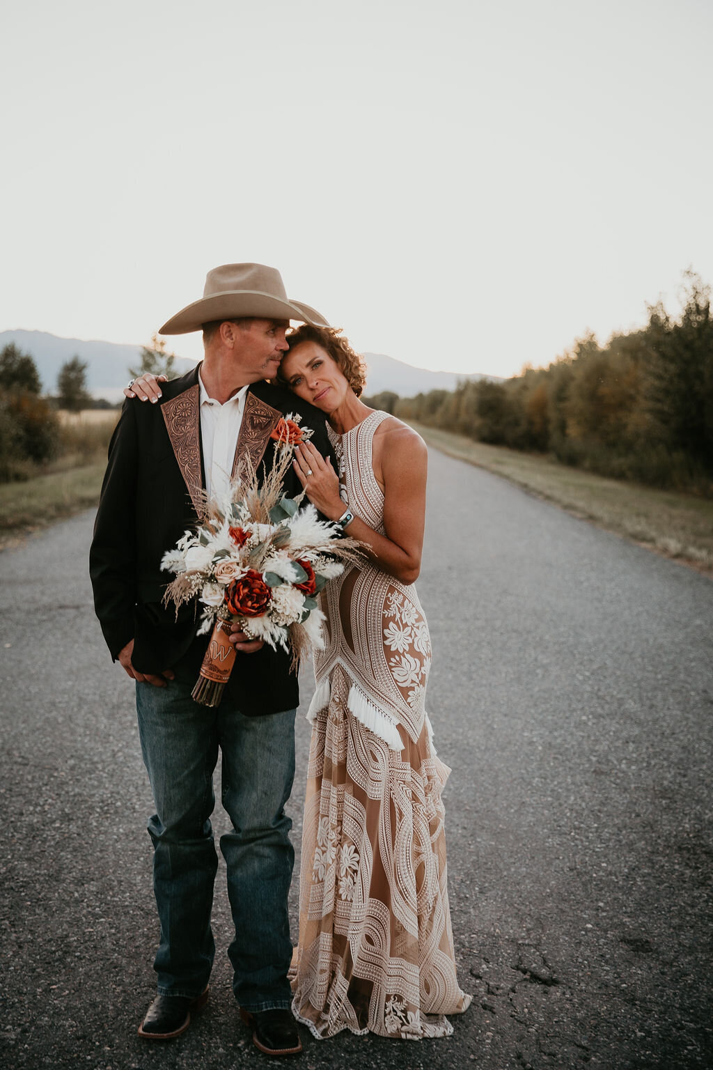 Bride and groom at sunset on a road