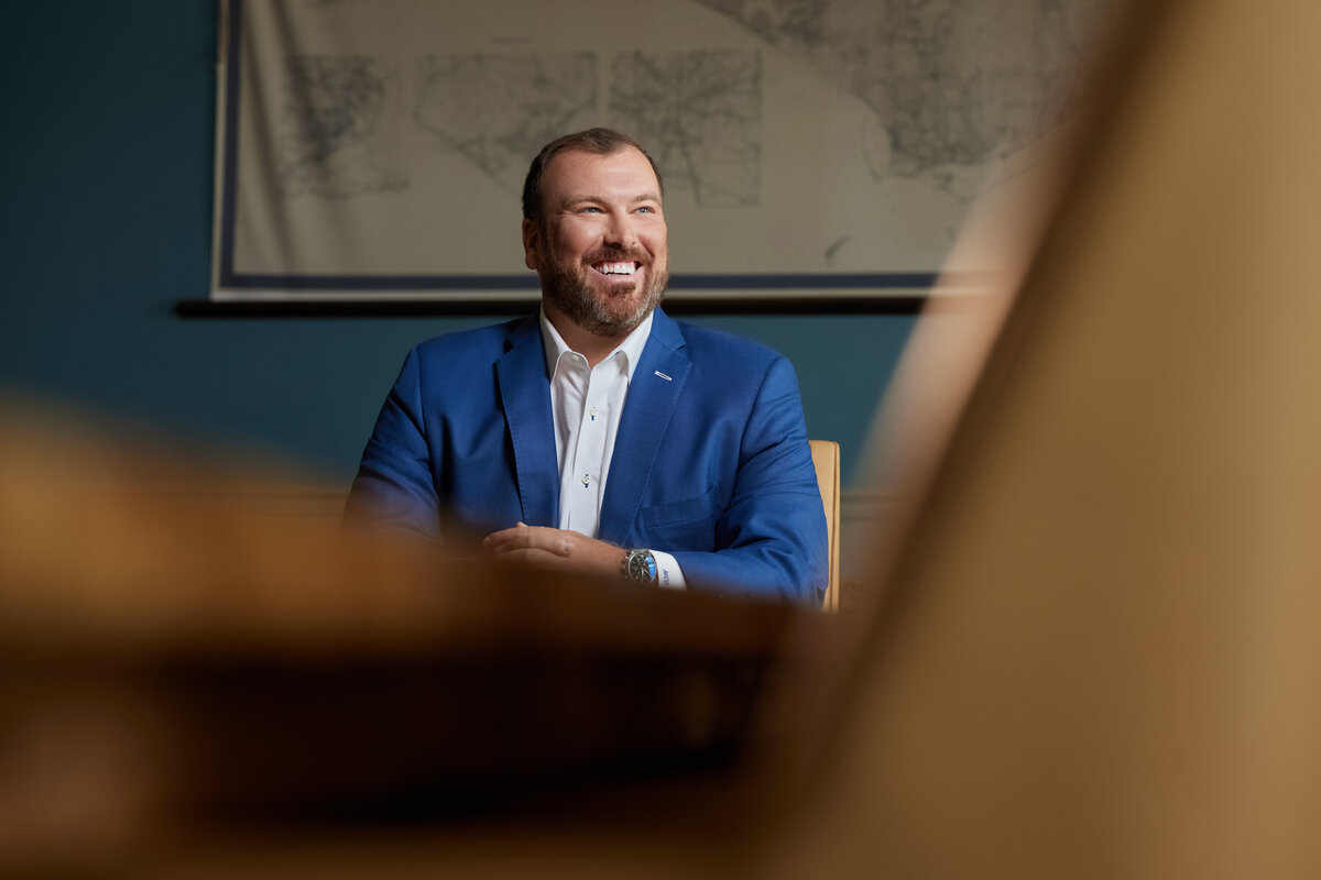 A man sitting at a table smiling