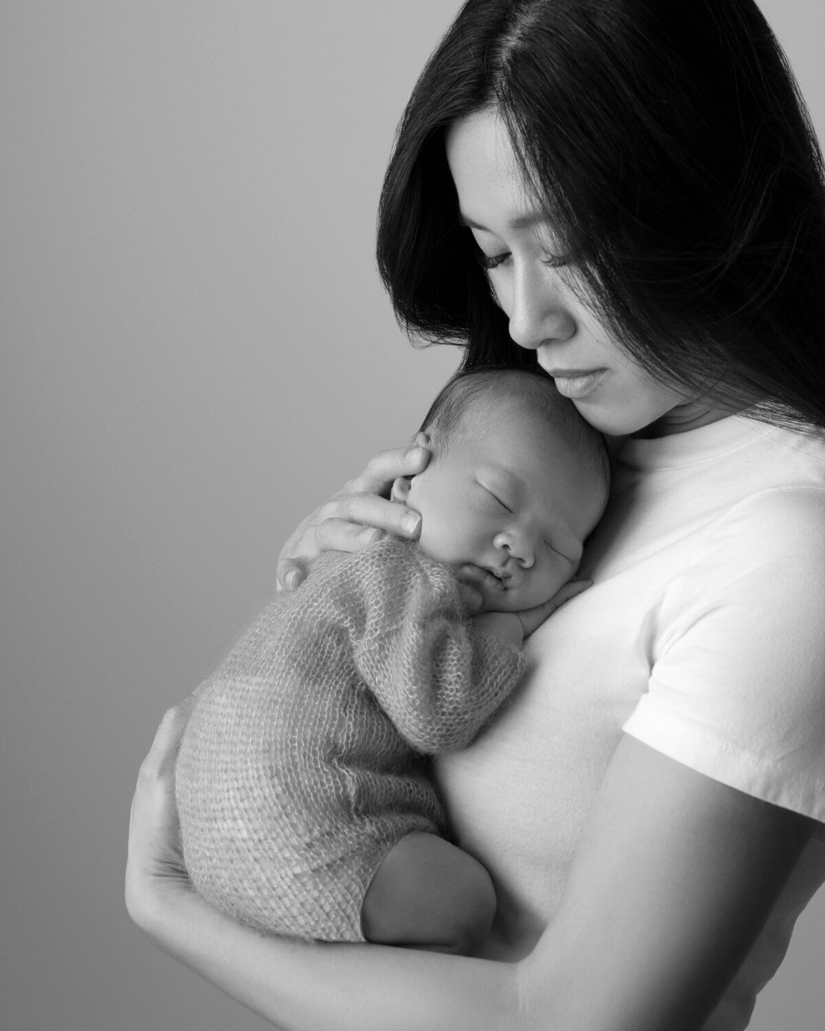 Black white mother holding newborn Round Rock lifestyle family photographer