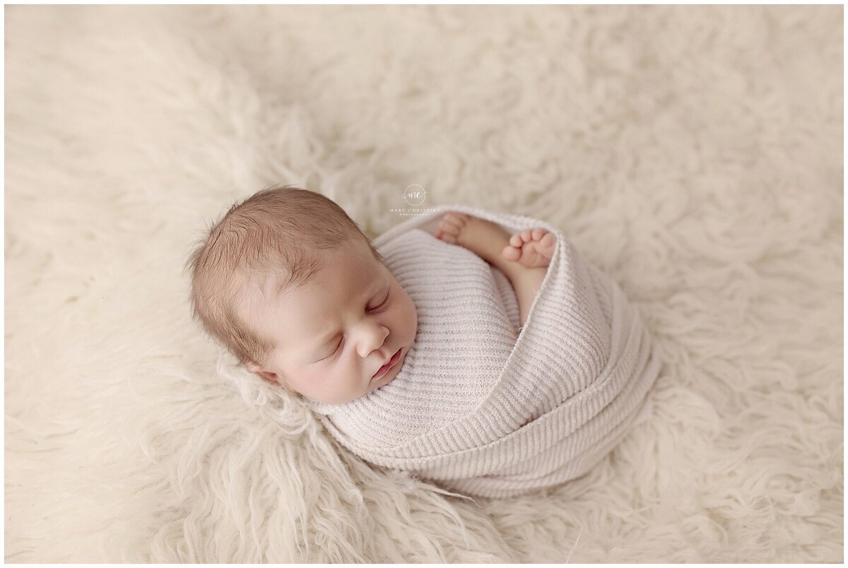 a wrapped baby ready for photos in Medina Ohio photography studio