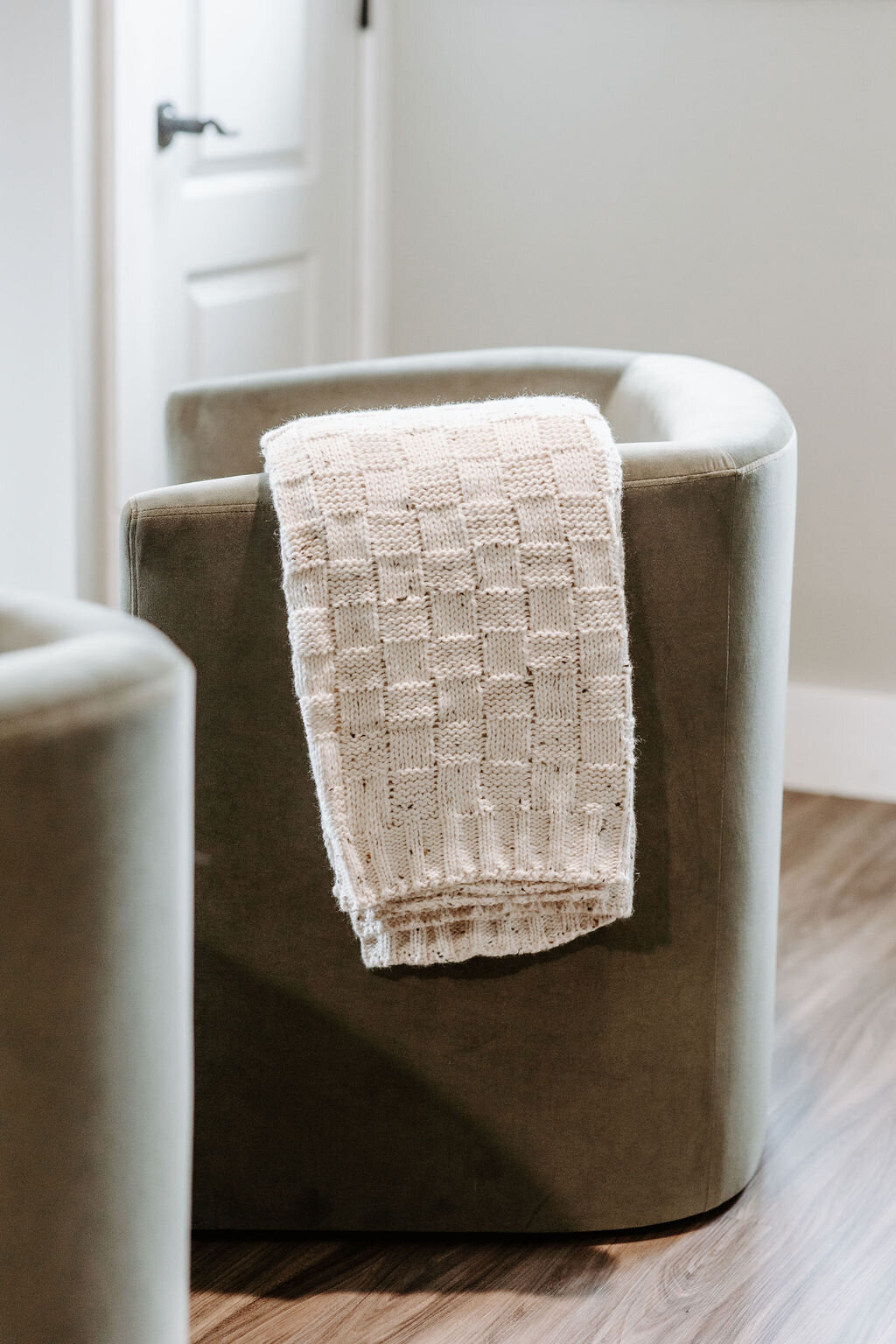 a green velvet barrel chair with a neutral throw blanket by mcgee studio in the overnight suite at Willowbrook wedding venue in PIttsburgh