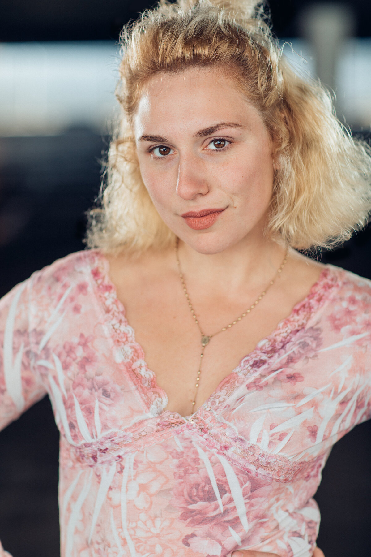 Headshot Photograph Of Young Woman In Pink V-Neck Blouse Los Angeles