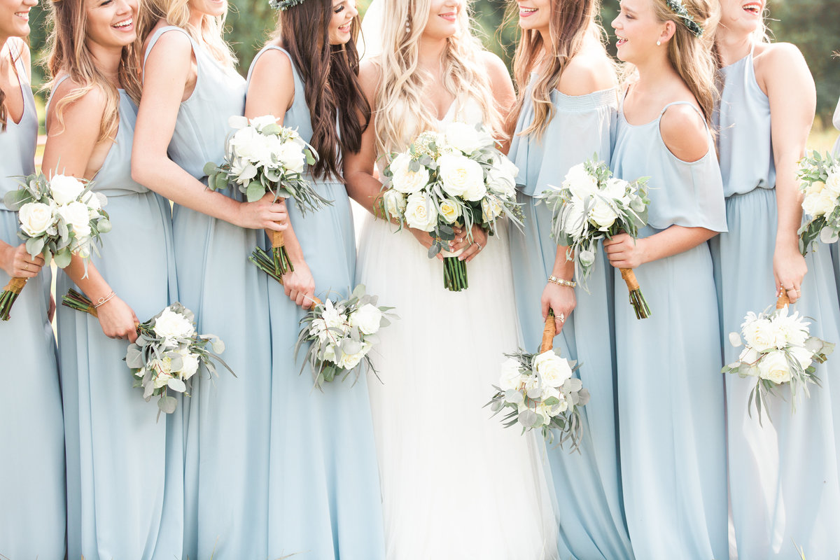 summertime bridesmaids holding bouquets