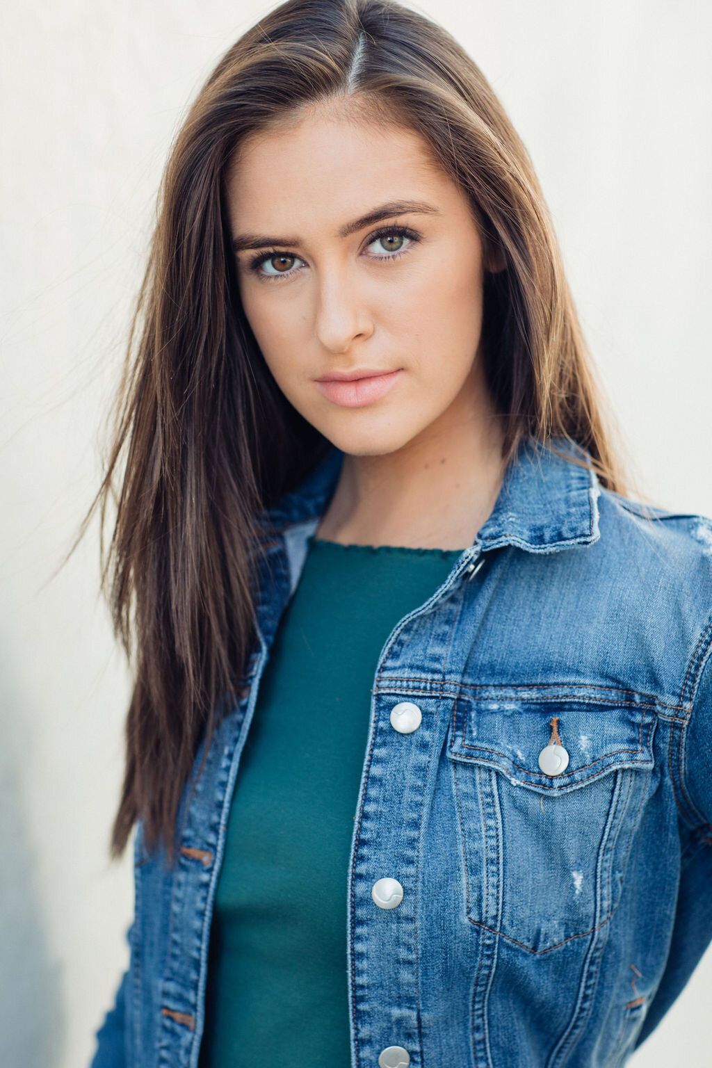 Headshot Photograph Of Young Woman In Outer Blue Denim Jacket And Inner Blue Shirt Los Angeles