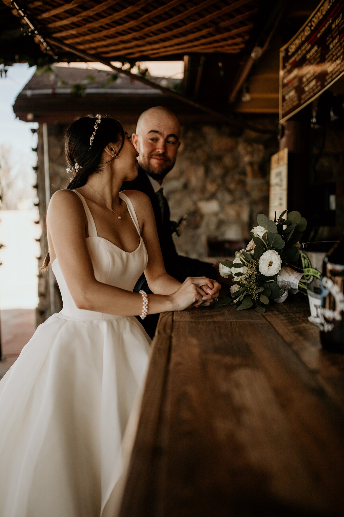 bride and groom standing at a bar together in New Mexico