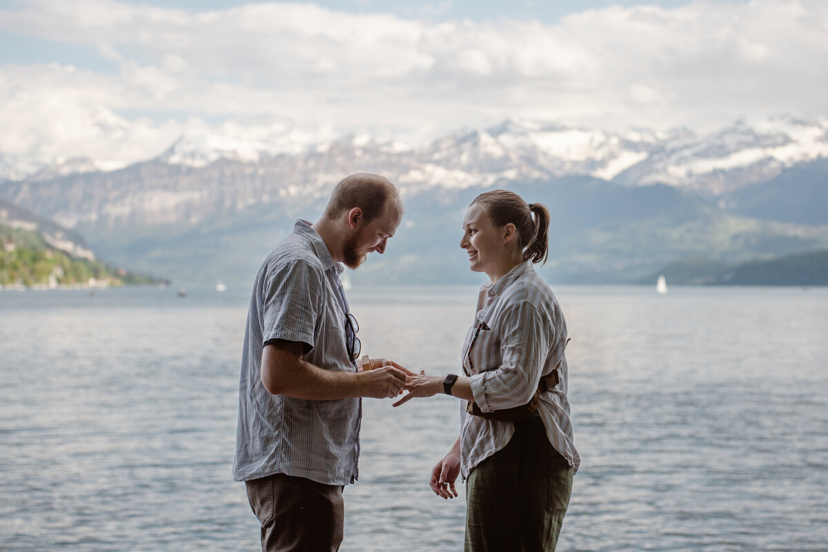 A person putting a ring on their partner's finger