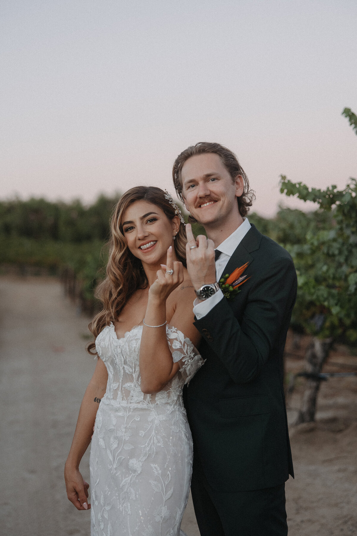 leoness cellars wedding, bride and groom showing rings to camera