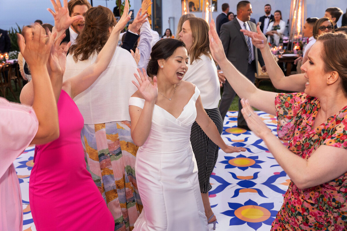 bride and friends dancing