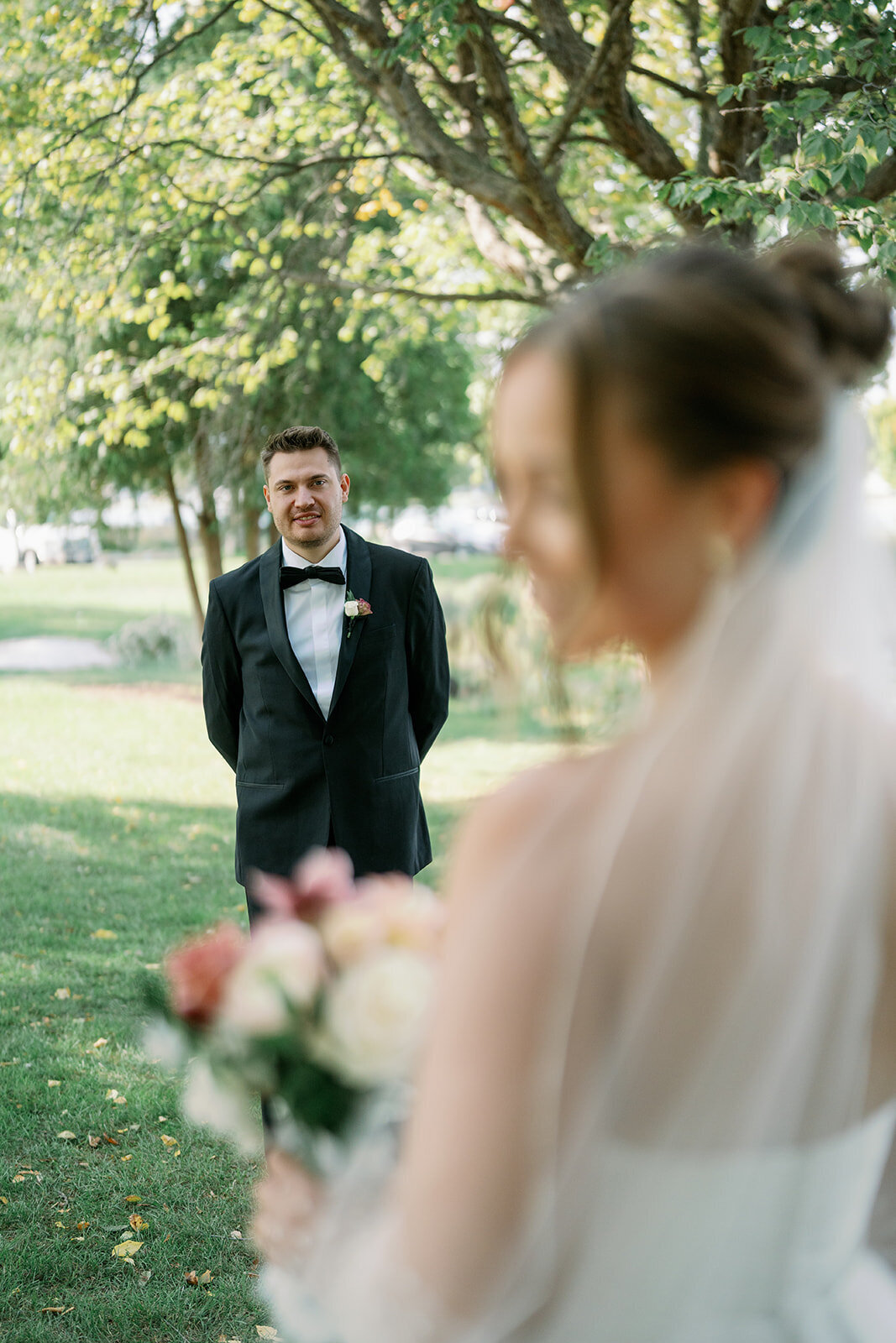 Romantic bride and groom waterfront portraits at Boatwerks in Holland Michigan with lakefront views captured by a Michigan wedding photographer.