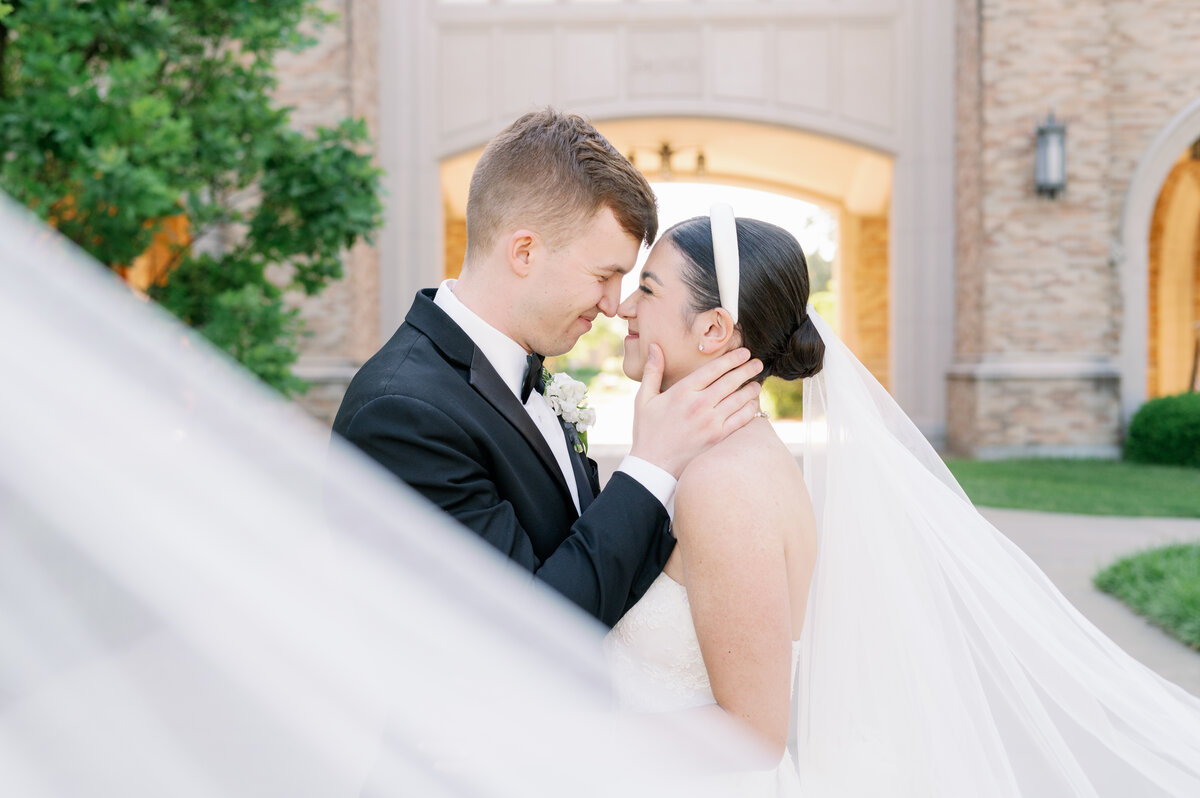 bride and groom smiling while touching noses