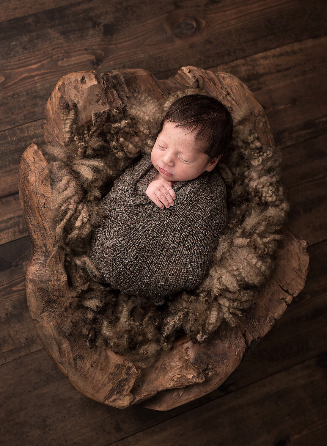 Wrapped Newborn in a creative  wood bucket