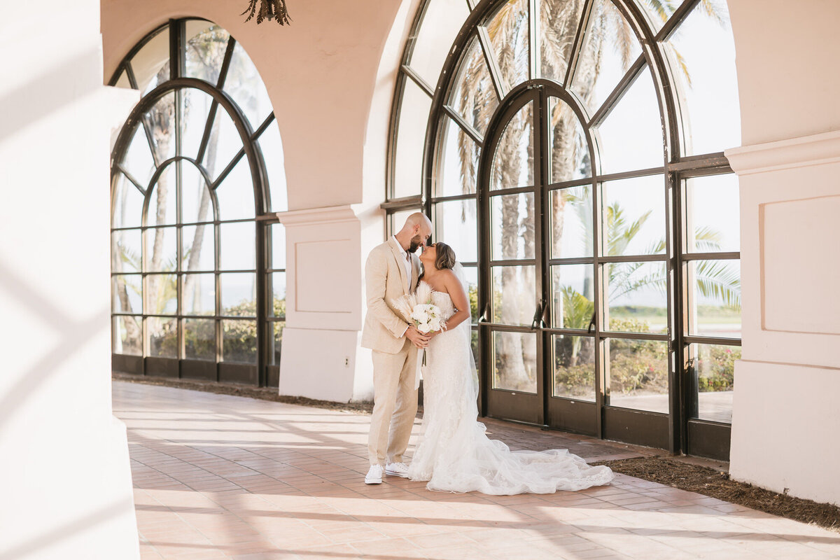 Bride and groom kissing at Hilton Beachfront Resort Santa Barbara