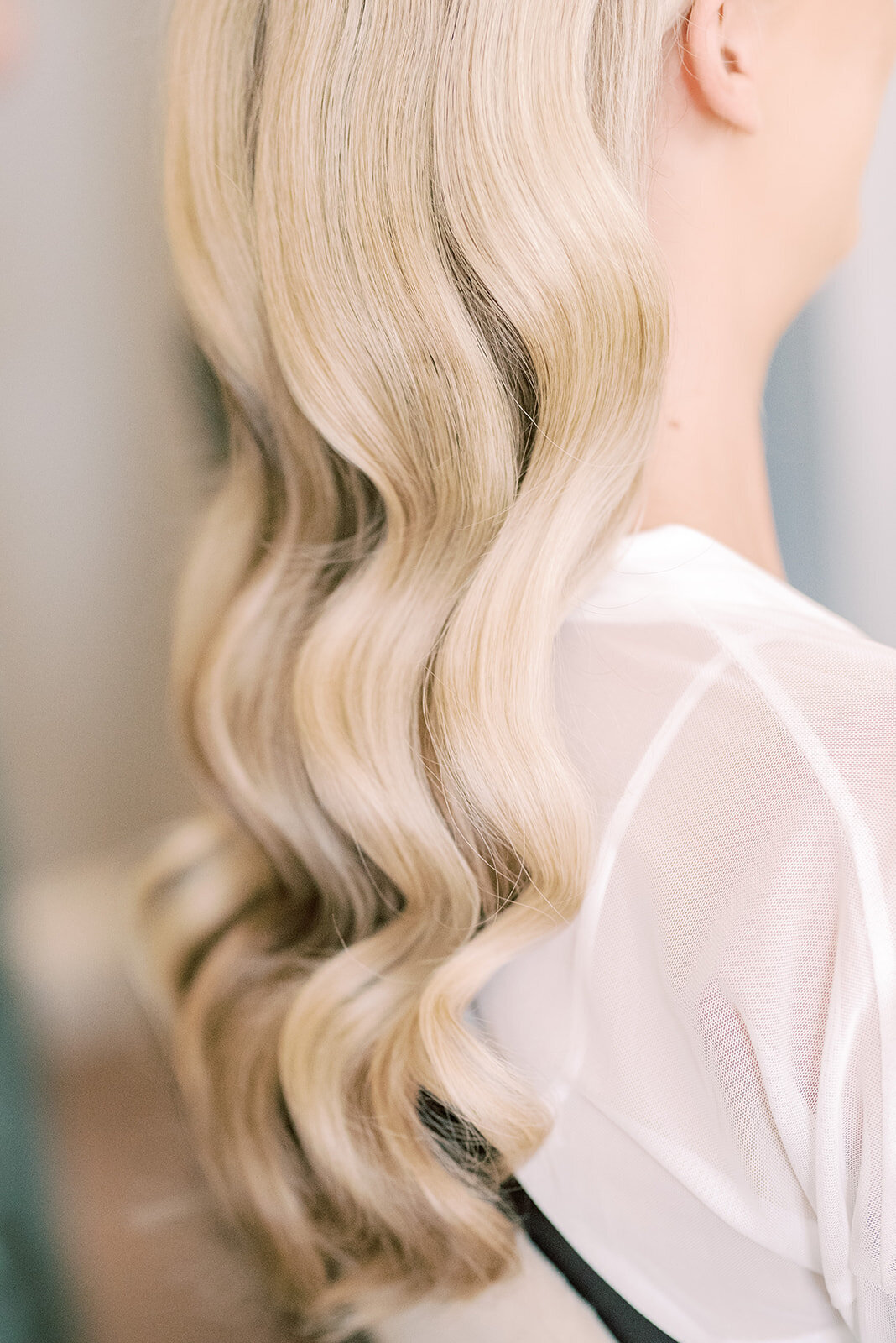 Detail shot of brides hollywood waves in her hair, the image is edited in a light and airy style