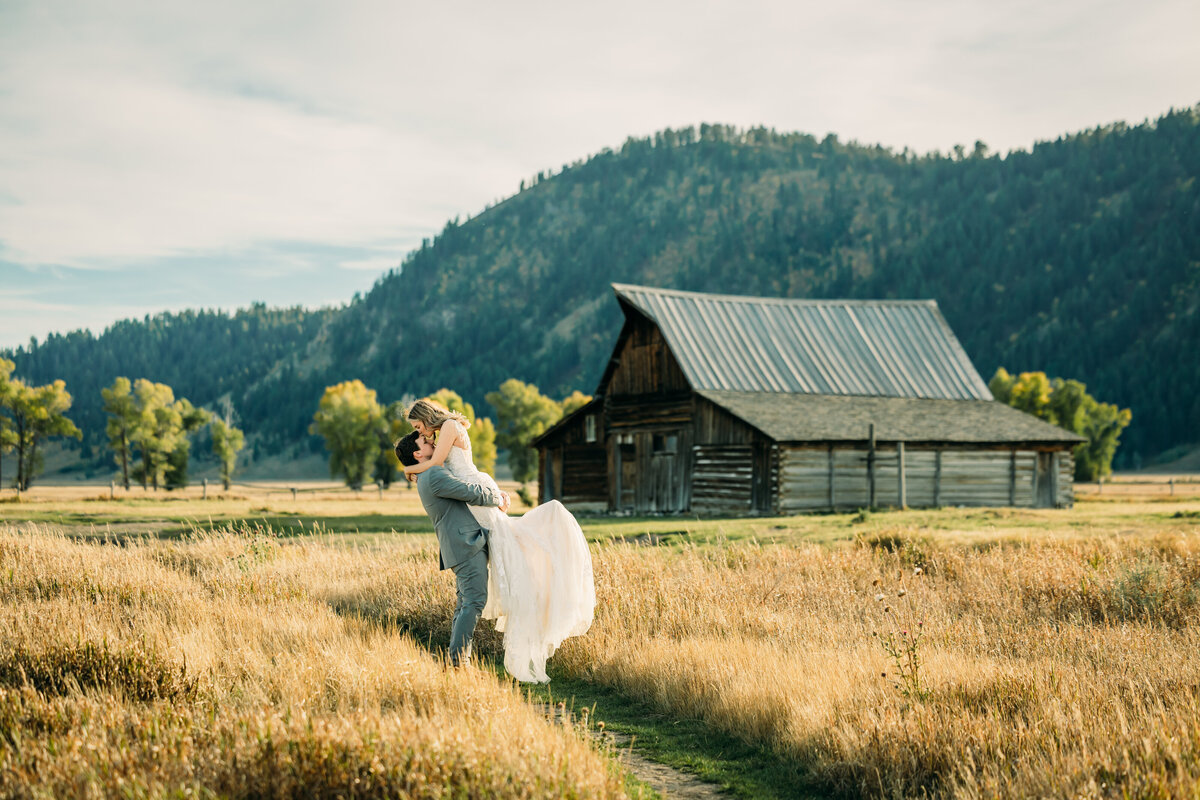 Grand Teton National Park Elopement Mormon Row TA Moulton Barn couple with tall grass and trees