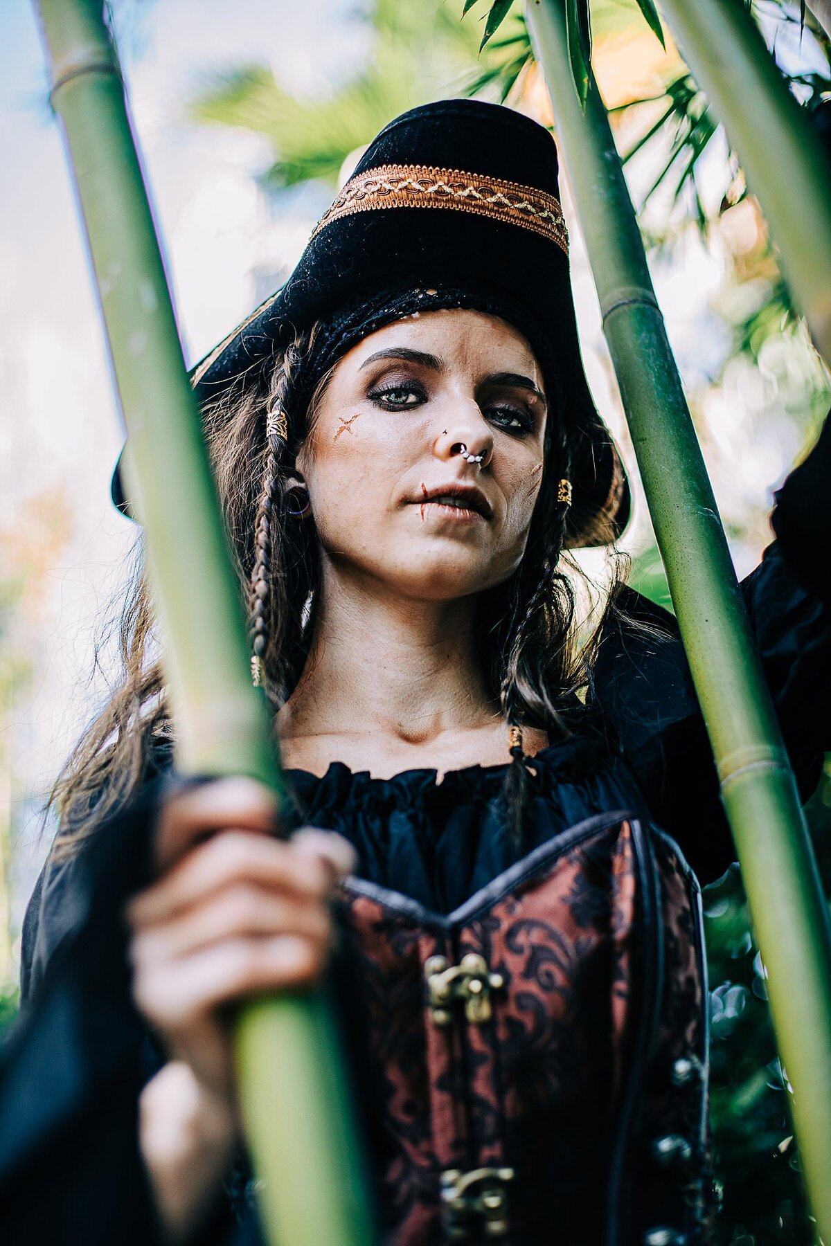 female pirate halloween costume and make up photoshoot in nature looking down mysteriously