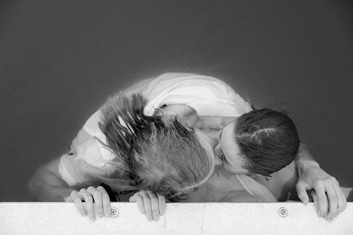 Couple seen face to face after having jumped in a lake together during their engagement photo session in Nashville, TN. 