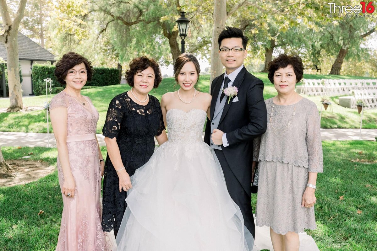 Bride and Groom pose for photos with the women in their lives
