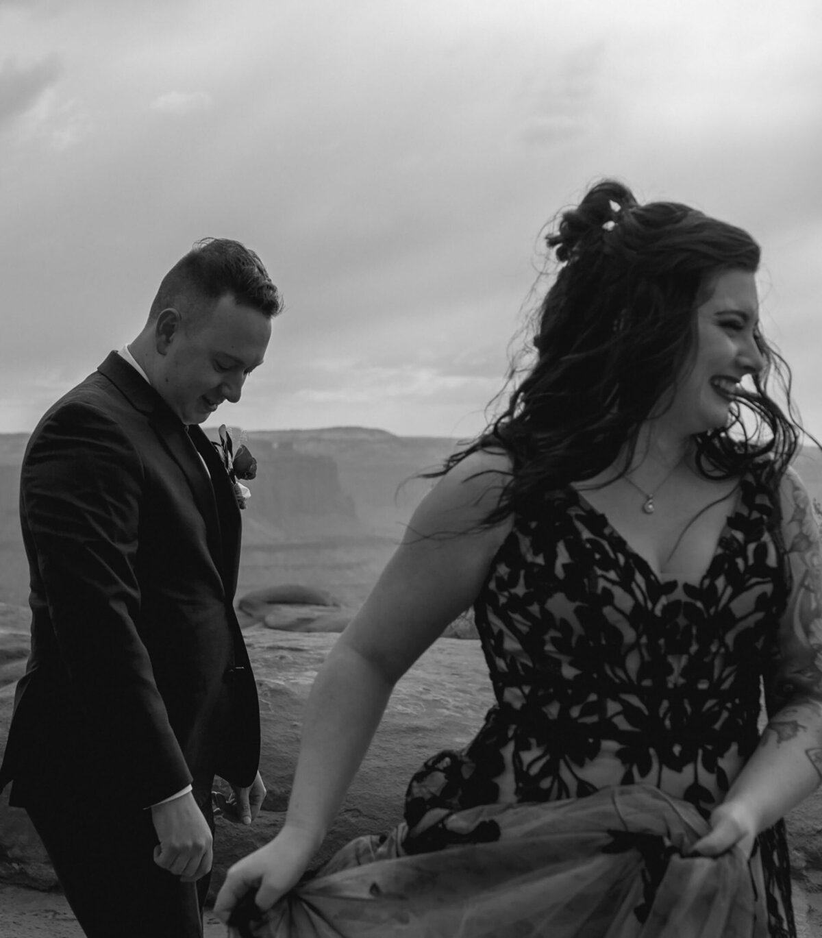joyous and fun loving couple smile and laugh after private elopement ceremony in Moab, Utah