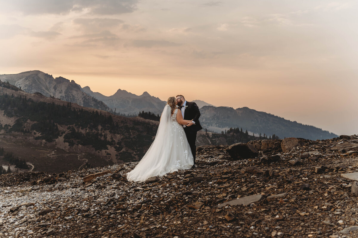 Bride and groom destination wedding sunset kissing photograph