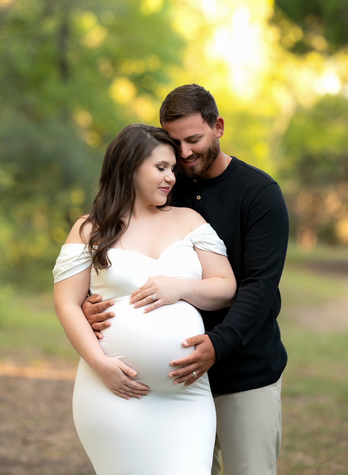 pregnant couple embracing mommas belly during maternity photoshoot at Brushy Creek Sports Park